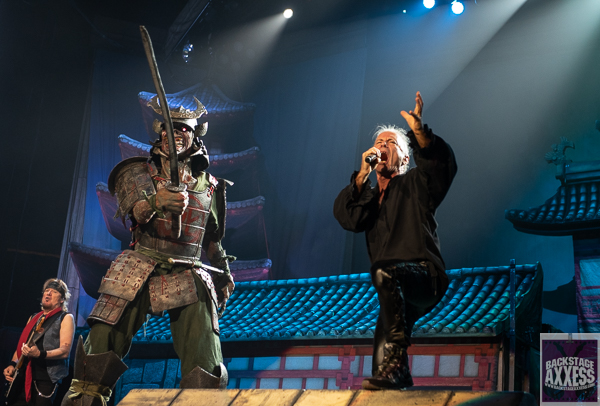 The singer poses and sings for the fan